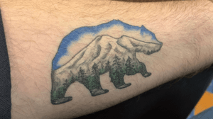 Bear outline with Mt Baker. The color of the trees, mountain, and sky reflect the colors of the Cascadian flag. 