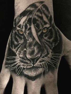 Realistic tiger on hand
