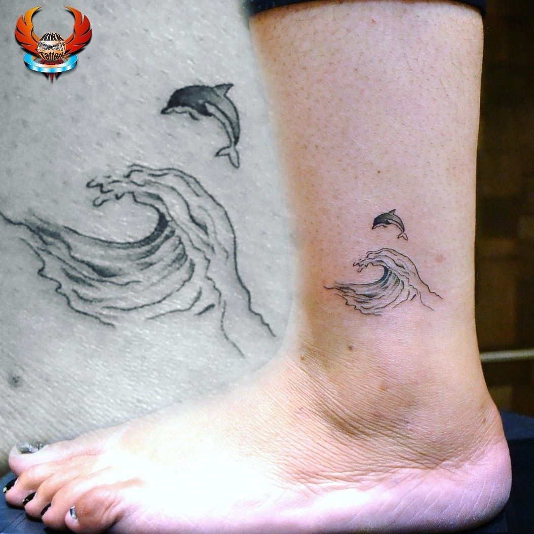 The Twisted Jester Tattoo Studio  Coverup tattoo of a dolphin by tiny t  tattoos dolphin flowers coverup legs ankle  Facebook