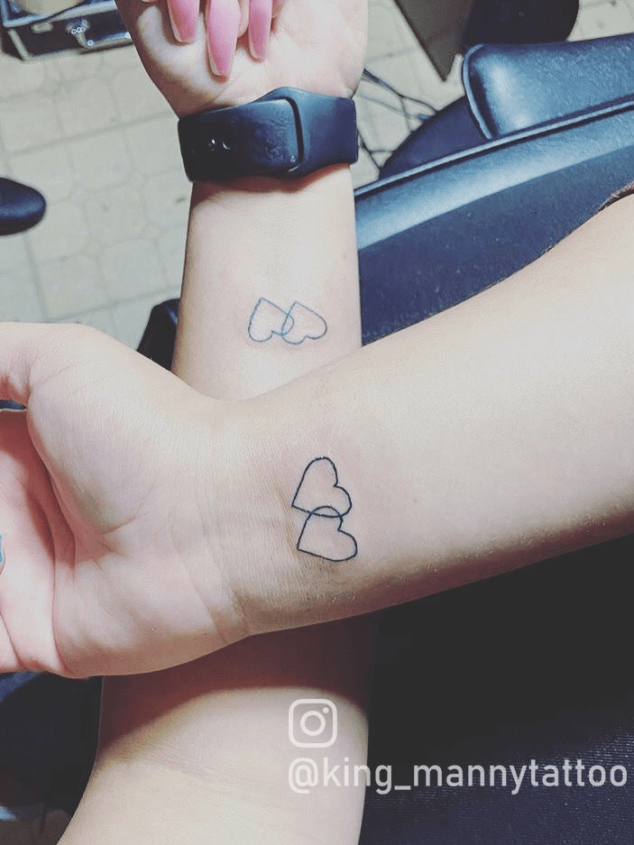 Sisters matching hearts tattoo on the wrist