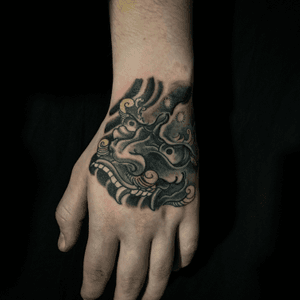 black and grey foo dog hand tattoo 