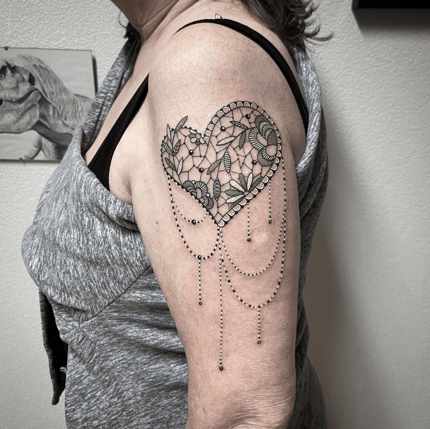 Floral heart tattoo on the back of the left thigh
