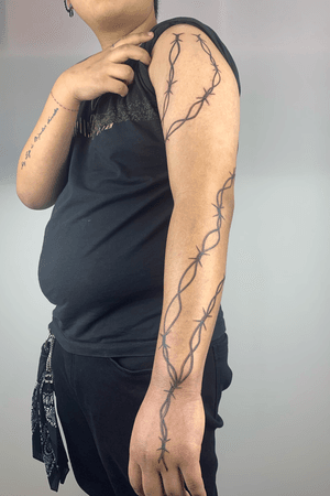 wire entanglements tattoo for man arm