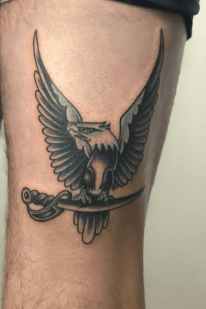 Traditional Eagle on back of thigh. Done in black and grey with a light blue silver gradient 