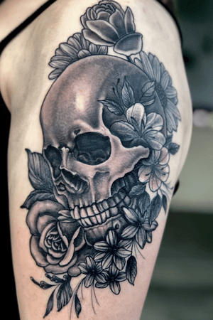 Skull and floral tattoo