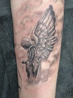 Angel in the clouds forearm tattoo