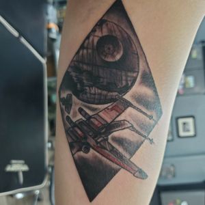 X-wing being chased down by a Tie fighter with the second Death Star in the background