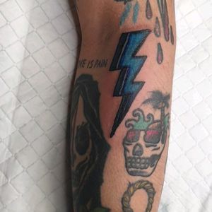 Traditional tattoo with a tinge of colour pop for bright blue lightning bolt.