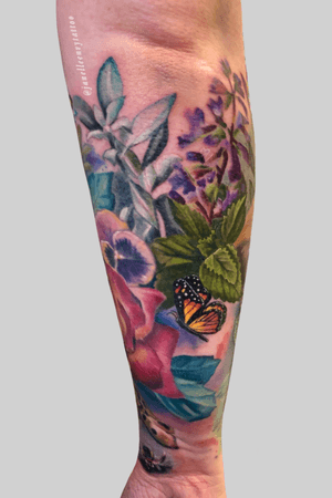 Hue back of my clients lower half sleeve with her cat on the other side.