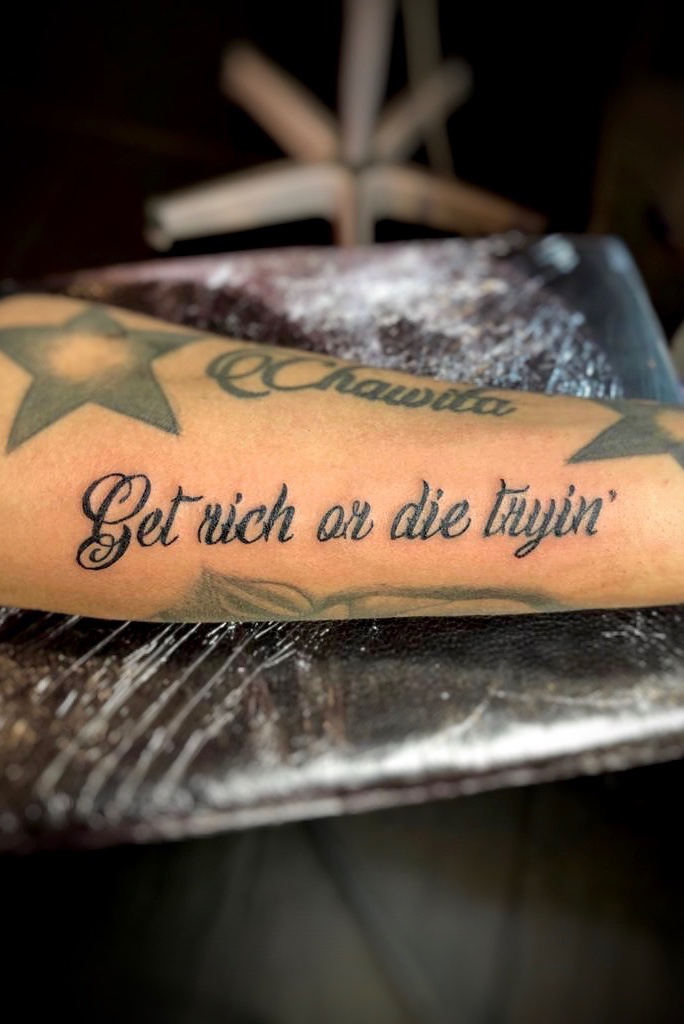 Fan gets Get Rich Or Die Tryin tattoo on his leg at 905 Ink Tattoo