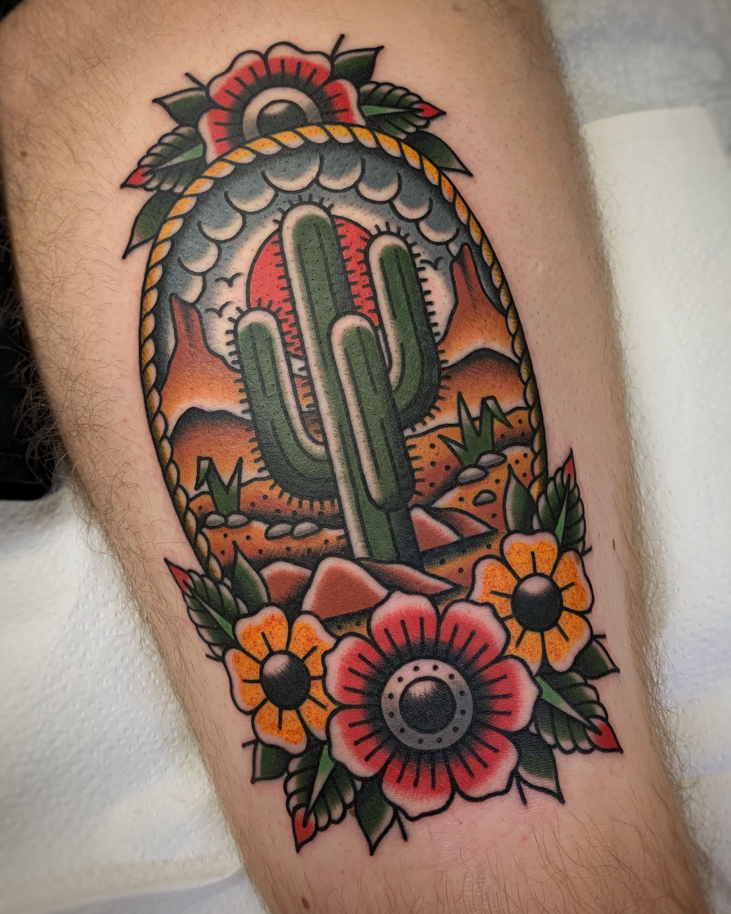 Arizona desert scene tattooed on the upper arm