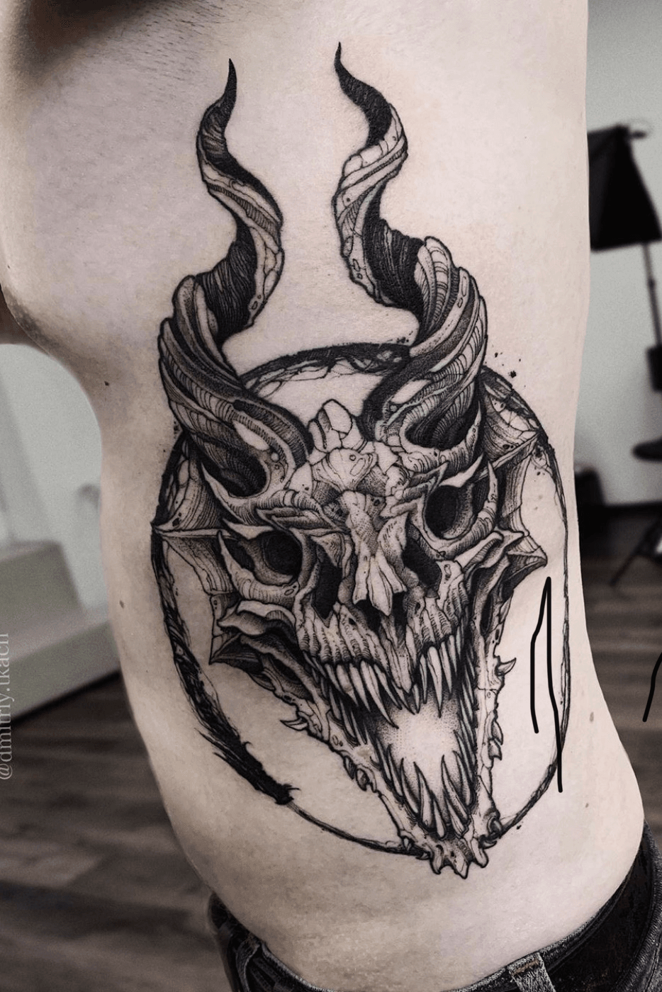 Blackwork style skeleton dragon tattooed on the