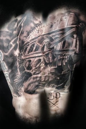 Experience the power and strength of a warrior in this stunning black and gray realism tattoo by the talented artist Mauro Imperatori. This piece captures the essence of ancient combat in a modern style.