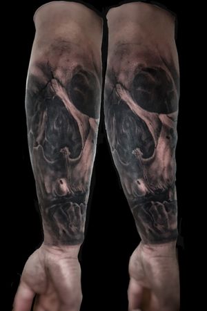 Get a striking black and gray skull tattoo on your forearm by the talented artist Mauro Imperatori. Perfect for those who want a bold and edgy look.