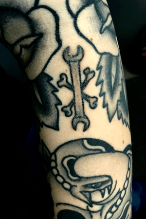 Little black and grey American traditional wrench with cross bones filled (still healing) 