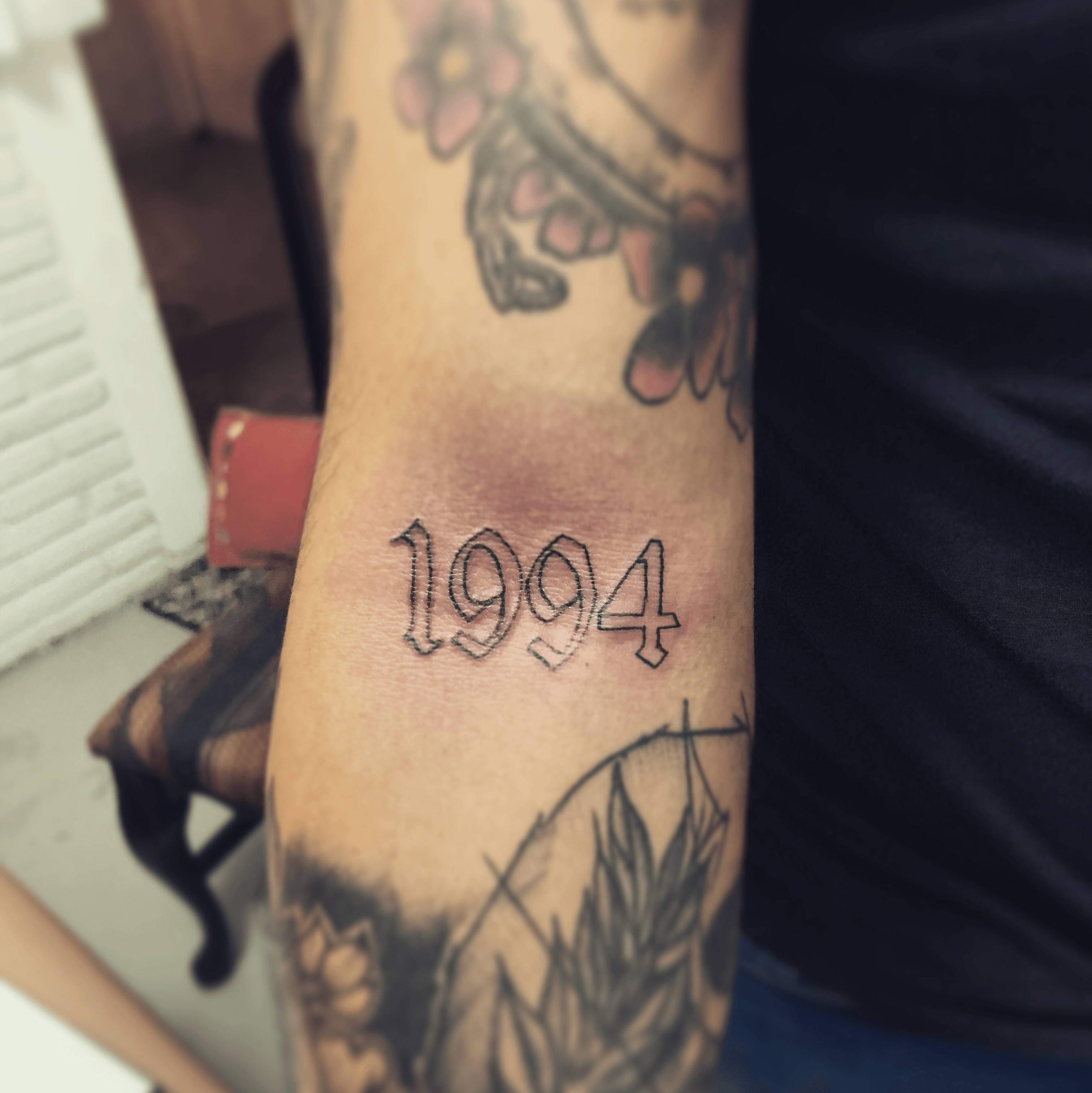 Large 1994 lettering tattoo located on the shin