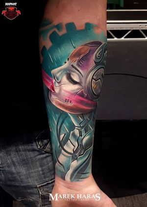 Get mesmerized by Marek Unfamous Haras' new school forearm tattoo featuring a surreal woman and robot design.