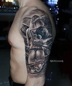 This stunning black and gray tattoo features a beautiful woman surrounded by celestial elements like planets, pearls, and shells, perfectly executed by Marek Unfamous Haras.