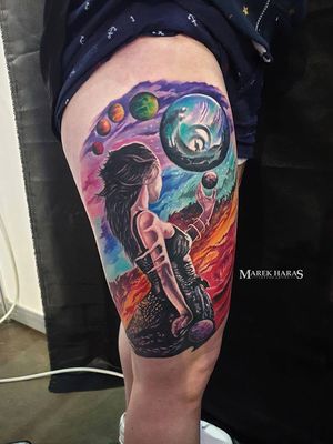 An illustrative new school tattoo on upper arm featuring a cosmic scene with a woman, girl, and planets, by Marek Unfamous Haras.