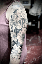 Floral sleeve. #floraltattoo #blackandgrey #sunflowertattoo #daisytattoo #lilytattoo #realismtattoo 