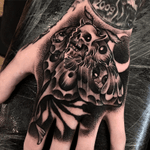 Moth hand tattoo