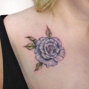 Light blue rose on chest, done with eternal ink.