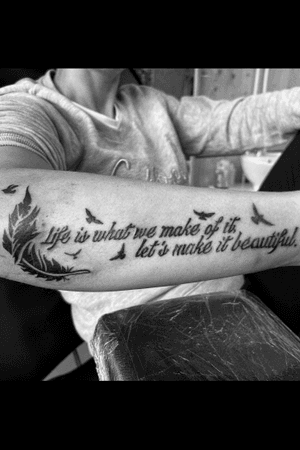 Lower arm tattoo with text