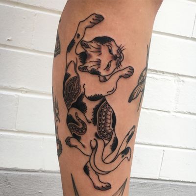 Bojji tattoo located on the upper arm, cartoon style.