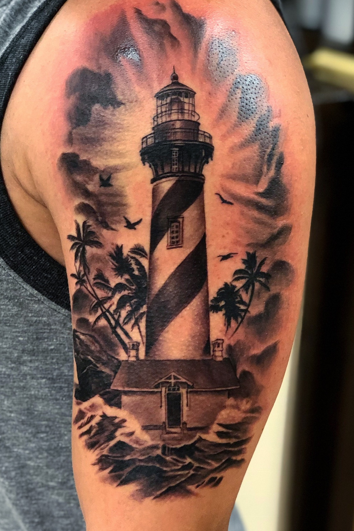 Small lighthouse tattoo on the ankle