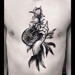 Tattoo by Michele Zingales #MicheleZingales #pomegranate #hand #flower #chest #blackwork