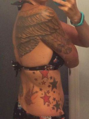 One of only a few pictures I have where you can see the angel/devil swallows on my lower back, the stars on my ribs, and a portion of my wings. Tattoos were all done by Jeffrey Tweed at Tranquility Tattoo 