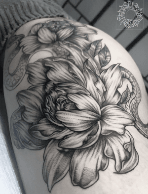 Elegant black and gray dotwork tattoo featuring a snake and peony motif, expertly done by Alejandro Gonzalez.