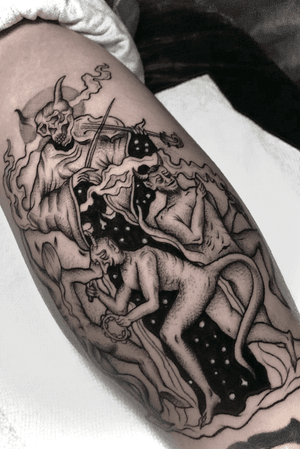 Get inked with a hauntingly beautiful black and gray forearm tattoo, featuring a devil, skull, and violin, masterfully done by Alejandro Gonzalez.