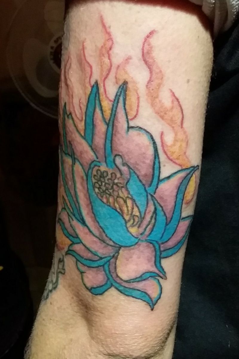 Tattoo uploaded by Inkology Nz • Blue flaming lotus. Above elbow. My first  colored lotus ever #lotus #flowertattoo #flamingflower #flames  #cartoonflower #cartoon #christchurch • Tattoodo