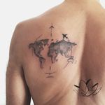 Globe and plane shoulder blade tattoo