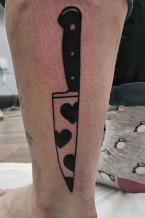 Vibrant new school design of a knife by Jonathan Glick on lower leg, exuding edgy and bold vibes.