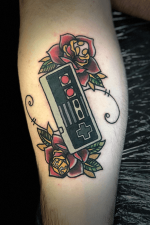 Way cool traditional NES remote with flowers tattoo. 