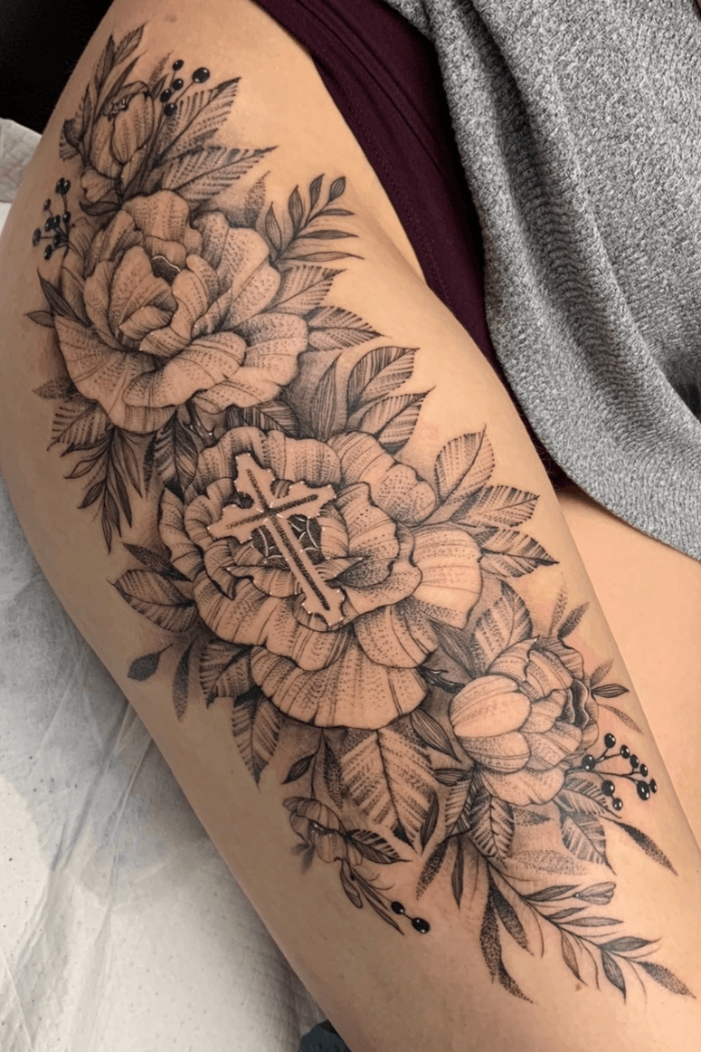 Fine line floral cross tattoo on the ankle