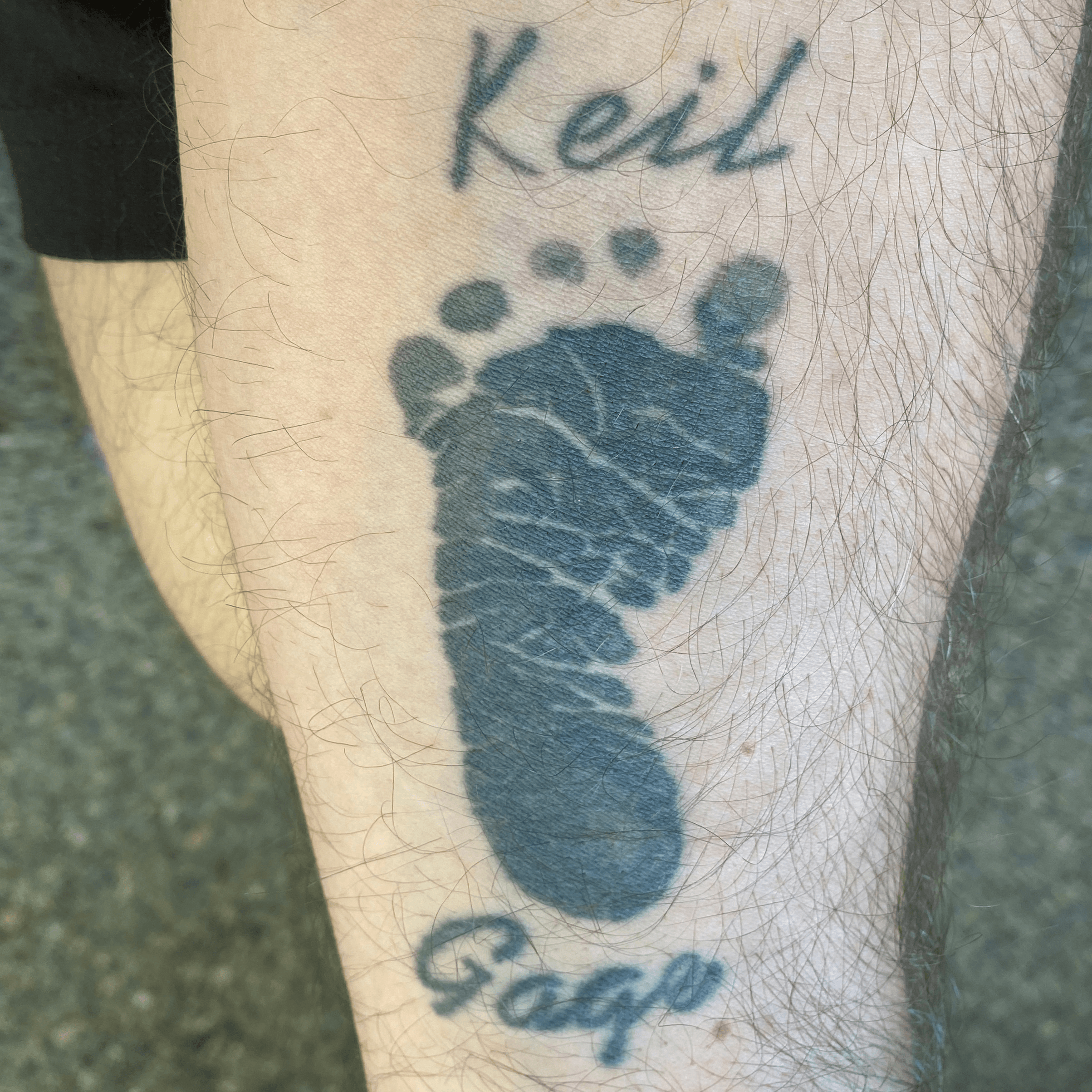 A young mother with tattoo on her arms holding the feet of her baby son in  her hands for white background Stock Photo  Alamy