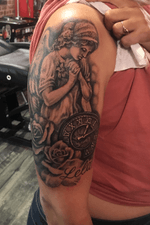 Angel roses and pocketwatch tattoo. Realistic blackandgrey upper arm tattoo