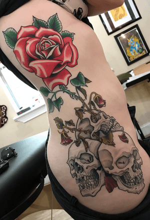 Very fun tattoo! It represents beauty growing out of darkness for her. I will always love skulls and roses 