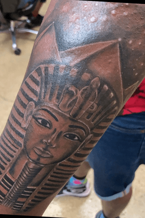 King tut with pyramid background