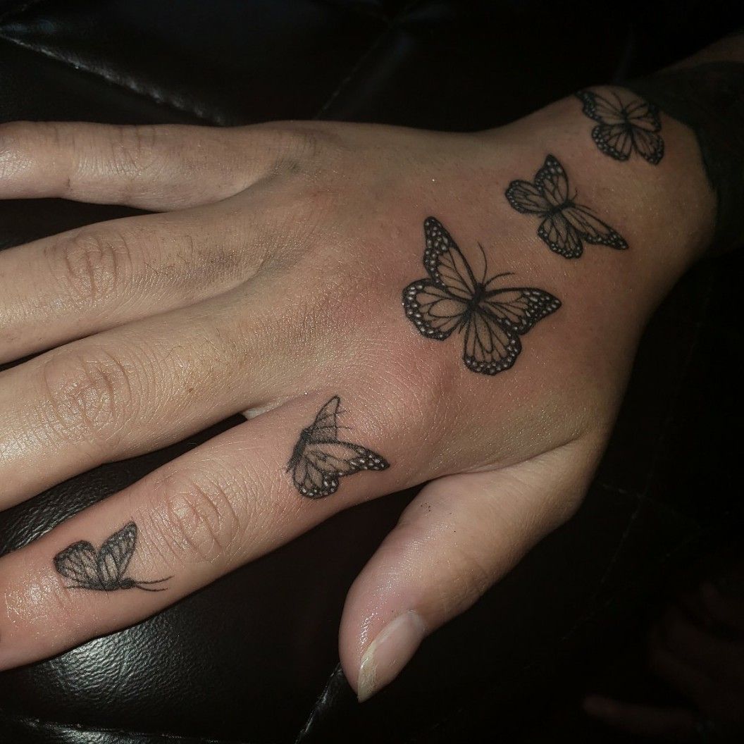 Flying Black butterfly hand tattoo
