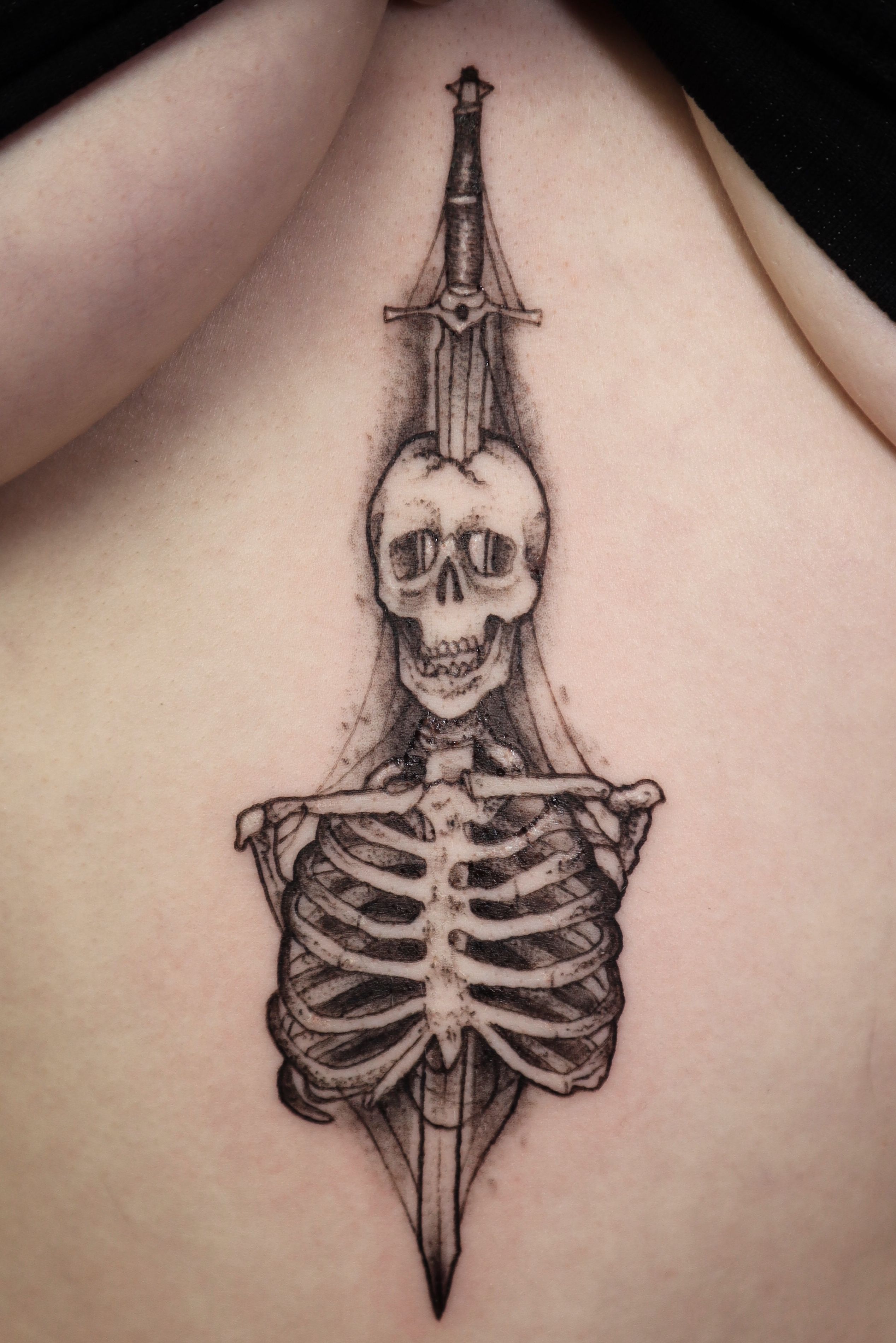 Fine line dancing skeleton tattoo on the ankle.