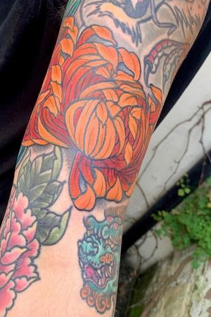 Japanese chrysanthemum cover up over a lotus pod on my left arm. 