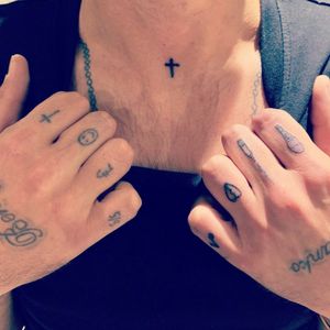 Handpoked finger and throat tats 
