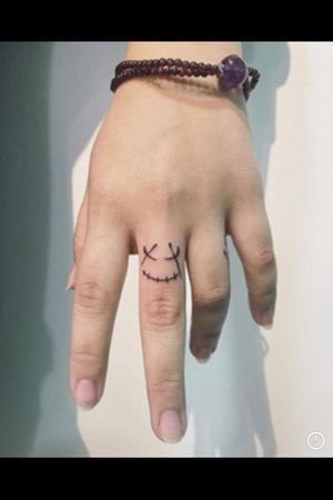 Smiley finger tattoo 