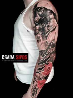 Intricate black and gray design featuring a flower, airplane, soldier, and mask. By Csaba Sipos.