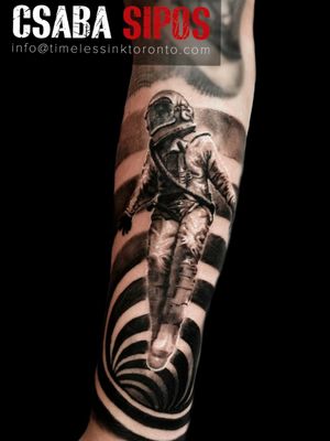 Csaba Sipos combines blackwork, geometric shapes, and realistic astronaut motif on your forearm for a celestial piece of art.