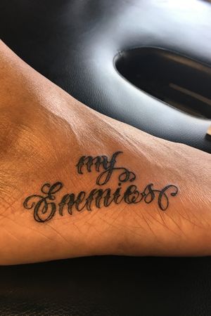 Lettering foot tattoo.
